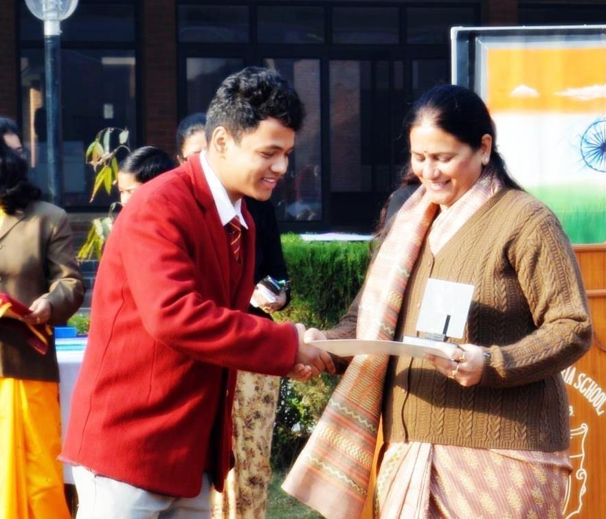 Ayush Rawat receiving a school achievement award